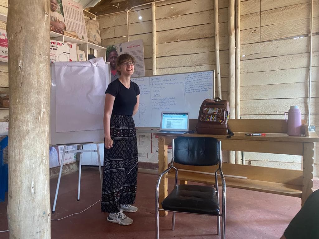 A facilitator speaking to young people in a lecture hall